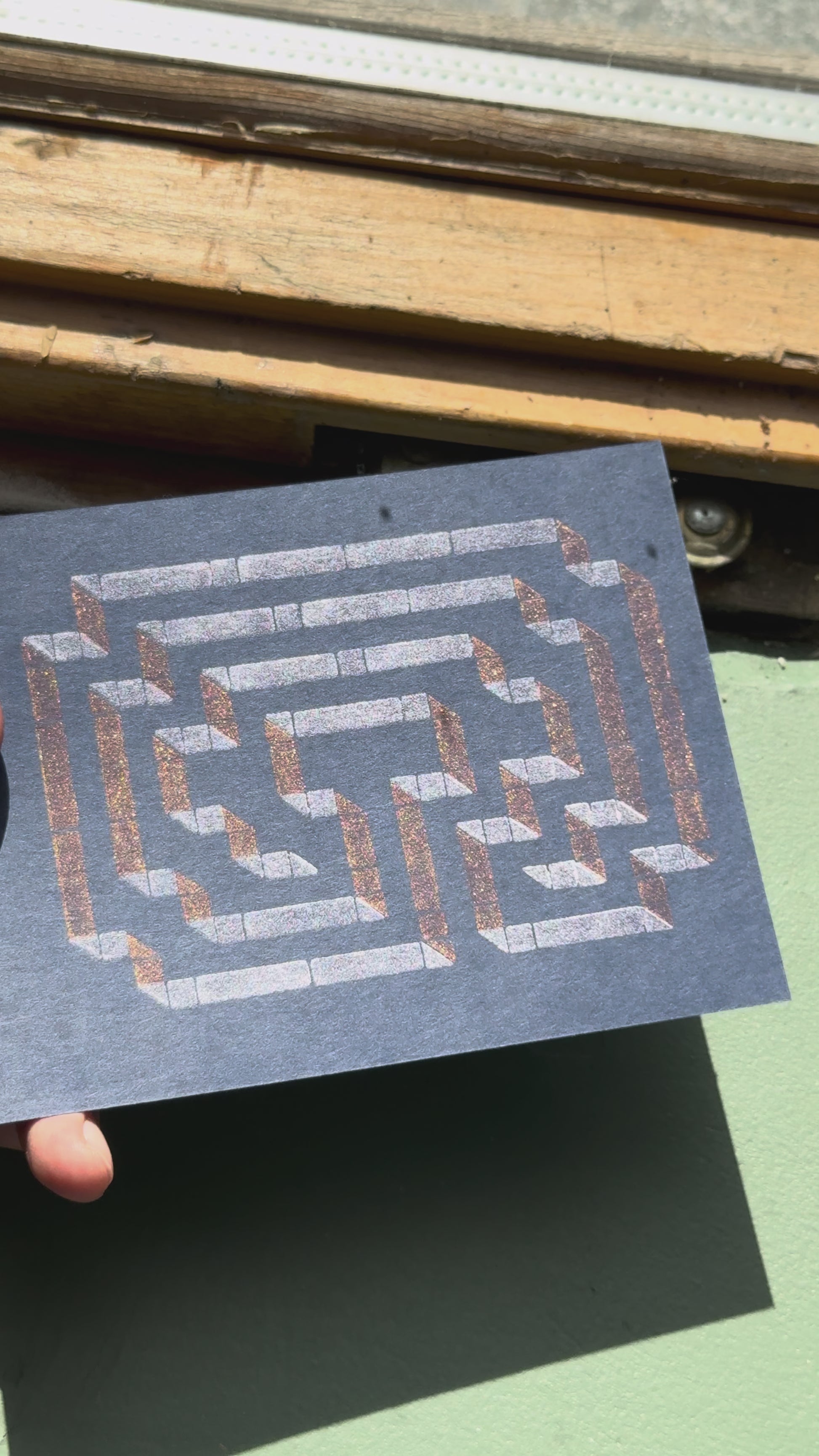 Print of a labyrinth on a piece of dark blue cardstock using Tsukineko Brilliance Cosmic Copper and Platinum Planet ink colors