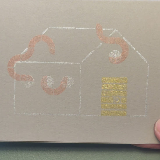 Print of a house with tentacles coming out of the windows on a piece of gray cardstock using Tsukineko Brilliance Planetarium ink colors