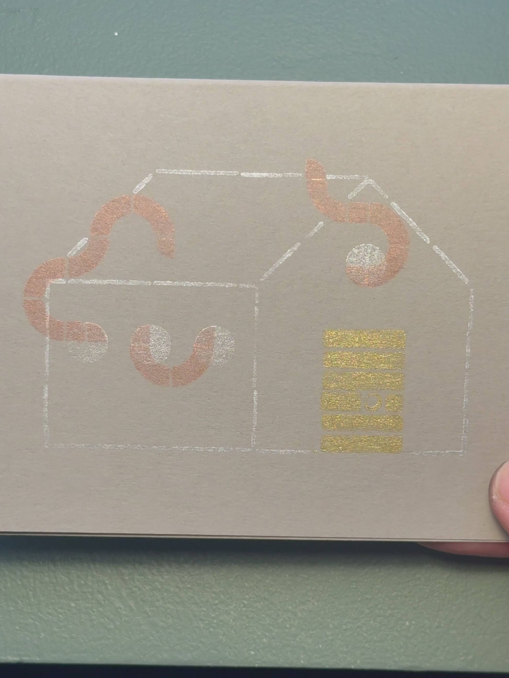 Print of a house with tentacles coming out of the windows on a piece of gray cardstock using Tsukineko Brilliance Planetarium ink colors