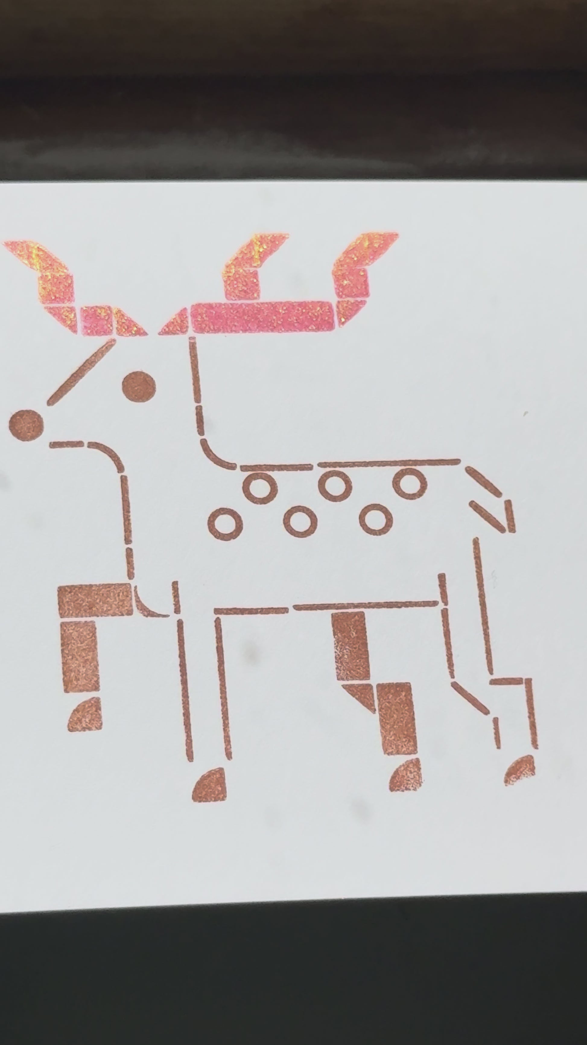 Print of a deer on a piece of white cardstock using Tsukineko Brilliance Rocket Red Gold and Coffee Bean ink colors