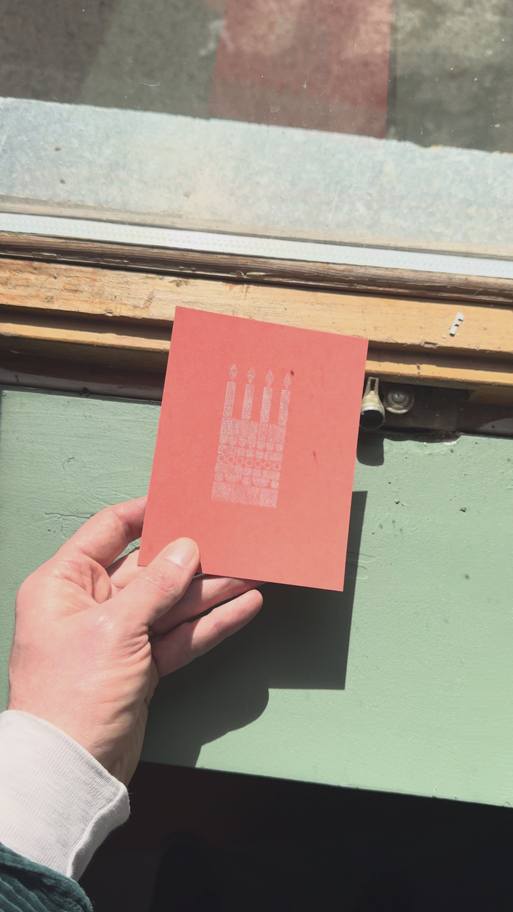 Print of a birthday cake on a piece of orange cardstock using Tsukineko Brilliance Platinum Planet ink