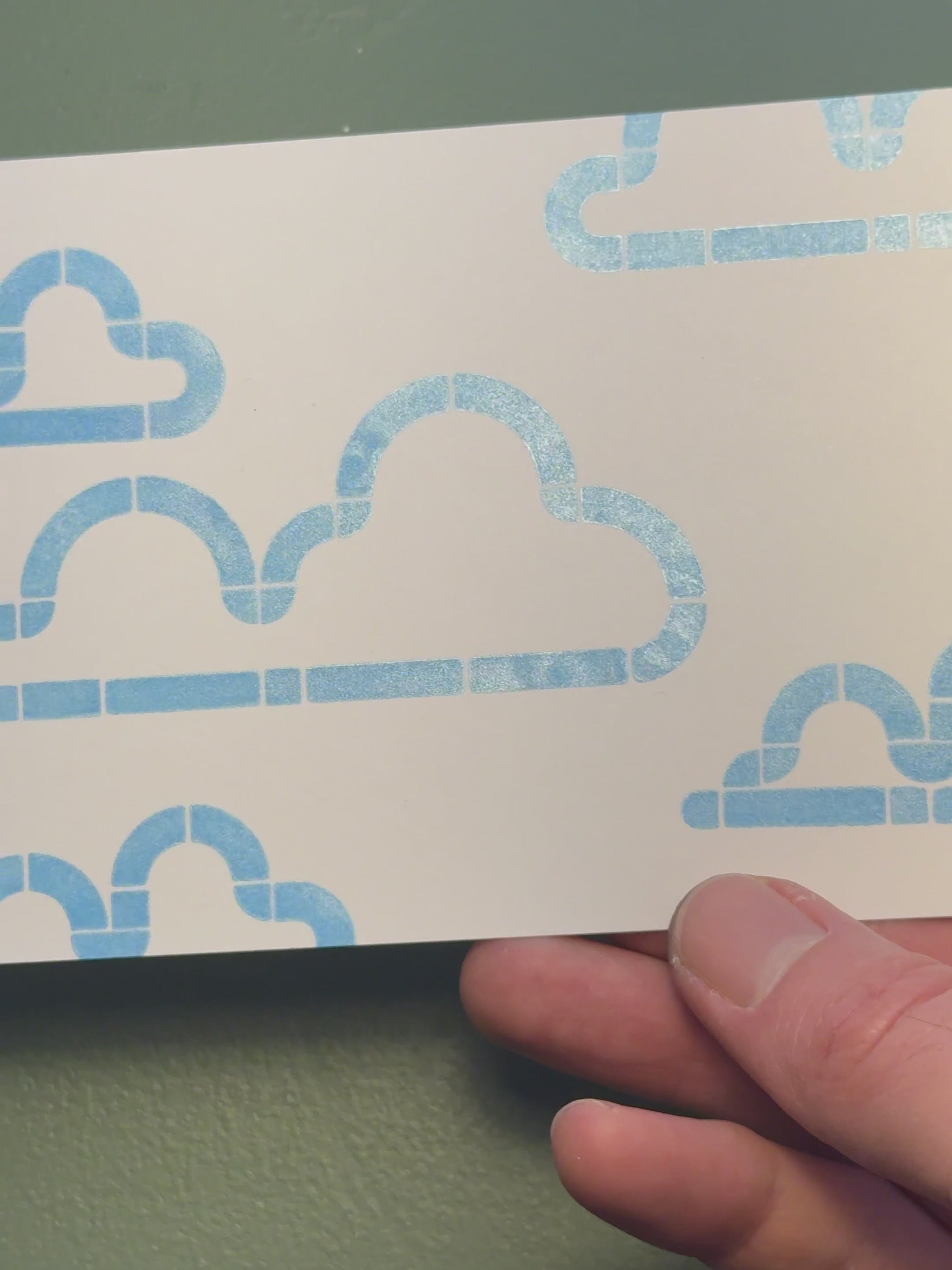 Print of clouds on a piece of white cardstock using Tsukineko Brilliance Pearlescent Sky Blue ink
