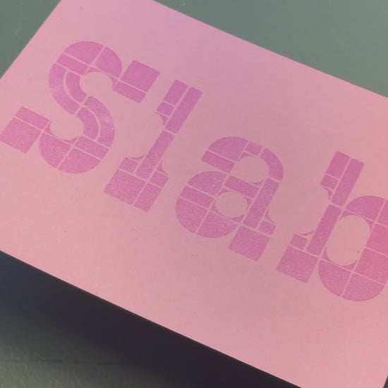 Print of a slab serif type example on a piece of pink cardstock using Tsukineko Brilliance Pearlescent Orchid