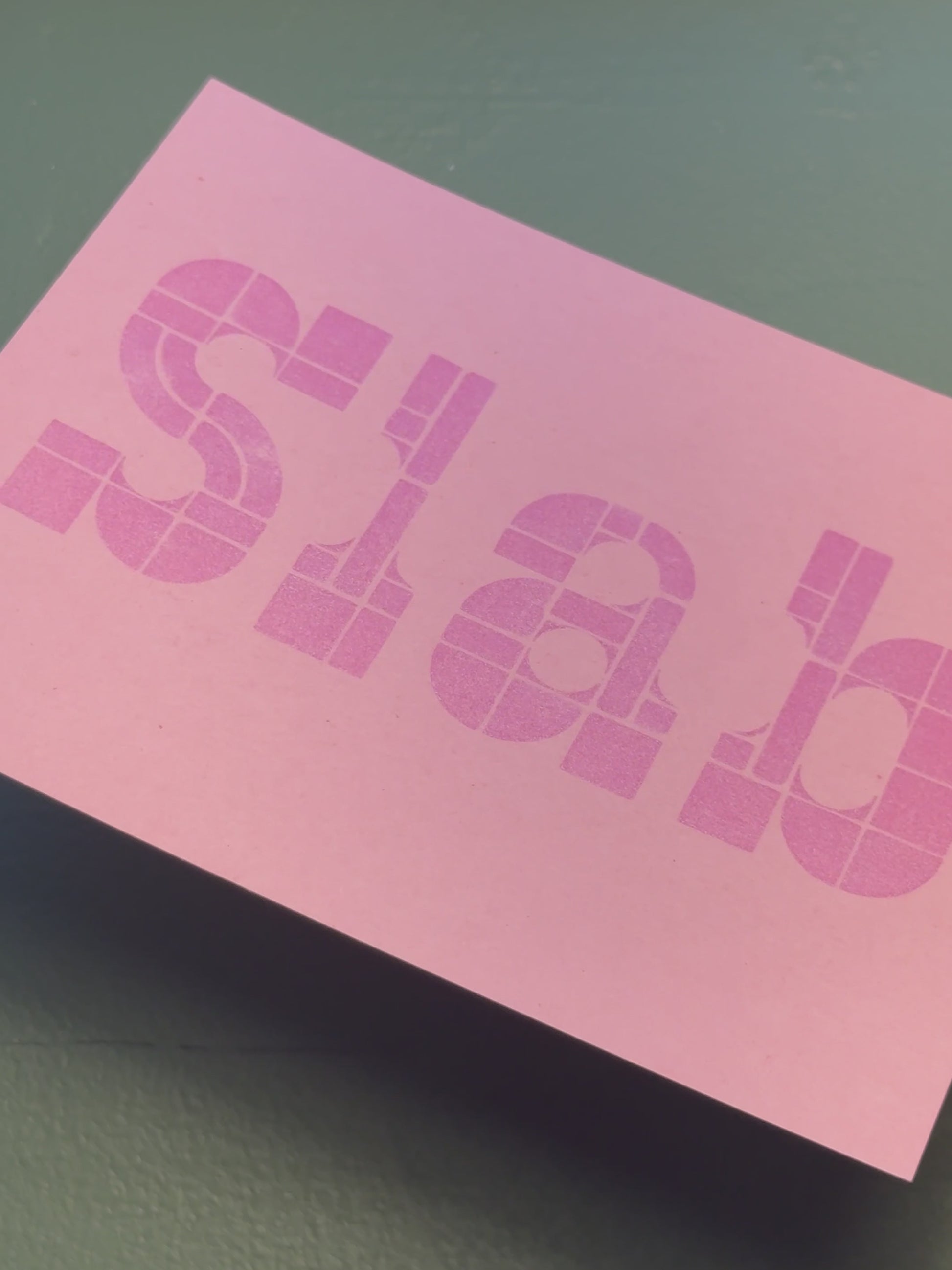 Print of a slab serif type example on a piece of pink cardstock using Tsukineko Brilliance Pearlescent Orchid