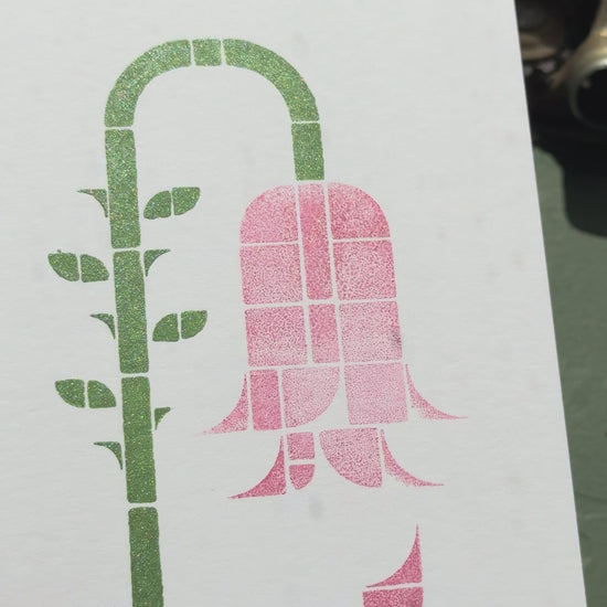 Print of a wilting rose on a piece of white cardstock using Tsukineko Brilliance Pearlescent Thyme and Rocket Red Gold ink colors