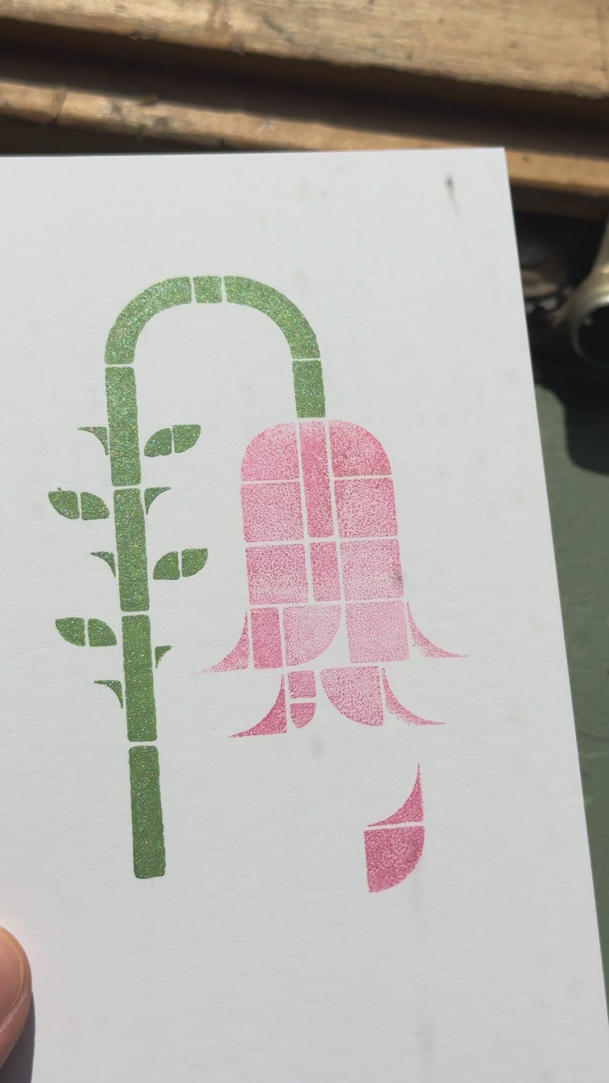 Print of a wilting rose on a piece of white cardstock using Tsukineko Brilliance Pearlescent Thyme and Rocket Red Gold ink colors